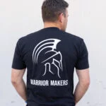 Back view of a man wearing the black Warrior Makers t-shirt with the large Spartan helmet and WARRIOR MAKERS back print