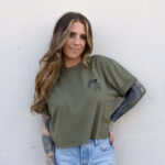 Woman wearing the army green Warrior Makers t-shirt with the Spartan helmet logo on the left chest