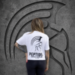 Back view of a woman wearing the white Warrior Makers PEPTIDES t-shirt with the large Spartan helmet and PEPTIDES back print